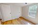 Bedroom featuring a closet, window, and neutral walls with vinyl floors at 1622 Julian Oakley Rd, Rougemont, NC 27572