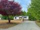 Home with a gravel driveway and lawn at 1622 Julian Oakley Rd, Rougemont, NC 27572