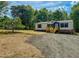 Home with a gravel driveway and lawn at 1622 Julian Oakley Rd, Rougemont, NC 27572
