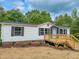 Charming home with a wooden porch, dark shutters, and brick accents at 1622 Julian Oakley Rd, Rougemont, NC 27572