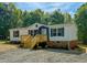 Charming single-story home with a wooden deck and beautiful landscaping at 1622 Julian Oakley Rd, Rougemont, NC 27572