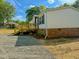 Exterior view showing a new deck with wood stairs and gravel parking at 1622 Julian Oakley Rd, Rougemont, NC 27572