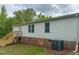 Exterior view of the home with wooden steps and vinyl siding at 1622 Julian Oakley Rd, Rougemont, NC 27572