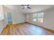 Living room with wood-look floors, ceiling fan, and large windows at 1622 Julian Oakley Rd, Rougemont, NC 27572