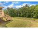 View of a backyard with a wooden deck and stairs leading down to the grass at 1811 Sandoval Dr, Durham, NC 27703