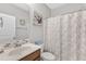 Cozy bathroom with tiled sink and shower with patterned shower curtain and gray walls at 1811 Sandoval Dr, Durham, NC 27703