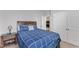 Cozy bedroom with dark wood furniture, soft blue bedding, and neutral walls at 1811 Sandoval Dr, Durham, NC 27703