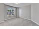 Spacious bedroom with large window offering plenty of natural light, neutral colors, and plush carpeting at 1811 Sandoval Dr, Durham, NC 27703