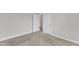 Neutral-toned bedroom highlighting the doors, carpet, baseboards, and electrical outlets at 1811 Sandoval Dr, Durham, NC 27703