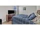 Comfortable bedroom with blue checkered bedding, wooden furniture, and natural light at 1811 Sandoval Dr, Durham, NC 27703