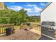 Outdoor deck furnished with a grill, and surrounded by trees at 1811 Sandoval Dr, Durham, NC 27703