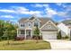 Beautiful two-story home with a well-maintained lawn, classic siding, and an attached two-car garage at 1811 Sandoval Dr, Durham, NC 27703