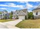 Inviting two-story home with a pristine driveway, manicured lawn, and a convenient two-car garage at 1811 Sandoval Dr, Durham, NC 27703