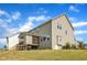 The backyard features siding, a screened porch and a green, gently sloping lawn under a blue sky at 1811 Sandoval Dr, Durham, NC 27703