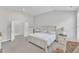 Well-lit main bedroom with a large bed, bedside tables, lamps, and an open closet at 1811 Sandoval Dr, Durham, NC 27703