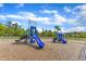 Community playground featuring blue slides and various play structures for residents' enjoyment at 1811 Sandoval Dr, Durham, NC 27703