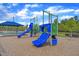 Community playground with bright blue slides, covered picnic area, and wood chip ground cover at 1811 Sandoval Dr, Durham, NC 27703