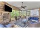 Inviting screened-in porch featuring cozy seating, a fireplace, and a view of the surrounding landscape at 1811 Sandoval Dr, Durham, NC 27703