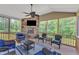 Inviting screened-in porch with comfortable seating, a ceiling fan, and a charming stone fireplace at 1811 Sandoval Dr, Durham, NC 27703