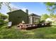 Inviting backyard deck featuring a sunroom and outdoor seating, perfect for relaxation and entertaining at 1820 Collier Rd, Durham, NC 27707
