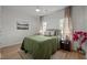 Bright bedroom featuring a ceiling fan, windows, and dark wood furniture at 1820 Collier Rd, Durham, NC 27707
