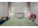 Bedroom with a large bed, matching side tables and curtains on dual windows at 1820 Collier Rd, Durham, NC 27707
