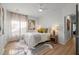 Bedroom with neutral decor, carpet, and a window with white translucent curtains at 1820 Collier Rd, Durham, NC 27707