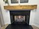 Inviting fireplace with wooden mantle at 1820 Collier Rd, Durham, NC 27707