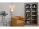 Cozy living room setting showcasing a modern armchair, built-in bookshelf, and updated decor at 1820 Collier Rd, Durham, NC 27707