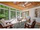 Bright sunroom with hardwood floors, wood ceiling and multiple windows at 1820 Collier Rd, Durham, NC 27707