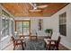 Bright sunroom with hardwood floors, wood ceiling, and comfortable seating at 1820 Collier Rd, Durham, NC 27707