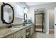 Bathroom featuring double vanity with granite counters and tiled walk-in shower with glass door at 199 Telluride Trl, Garner, NC 27529