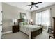 Cozy bedroom with ceiling fan, white shutters, and two bedside lamps for reading at 199 Telluride Trl, Garner, NC 27529