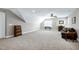 Large carpeted bonus room features a ceiling fan, shuttered windows, and comfortable seating at 199 Telluride Trl, Garner, NC 27529