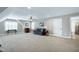 Spacious carpeted bonus room features a ceiling fan, two windows, and door to an ensuite bath at 199 Telluride Trl, Garner, NC 27529