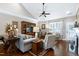Open living area with vaulted ceilings, a fireplace, and comfortable seating, perfect for relaxation and entertainment at 199 Telluride Trl, Garner, NC 27529