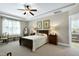 Serene main bedroom featuring a tray ceiling, plantation shutters, and neutral tones for a relaxing retreat at 199 Telluride Trl, Garner, NC 27529