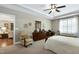 Bright main bedroom features a ceiling fan and plantation shutters, and is open to the connected sitting room at 199 Telluride Trl, Garner, NC 27529
