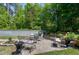 Lovely outdoor seating area featuring a stone retaining wall and lush greenery for a serene and inviting atmosphere at 199 Telluride Trl, Garner, NC 27529