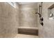 Walk-in shower features tiled walls, built-in bench, and recessed shelf for toiletries at 199 Telluride Trl, Garner, NC 27529