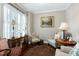 Cozy sitting area with natural light, comfortable seating, and classic decor, creating a relaxing atmosphere at 199 Telluride Trl, Garner, NC 27529