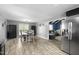 Open concept dining room with stainless appliances and hardwood floors at 2005 Chalybeate Springs Rd, Fuquay Varina, NC 27526