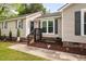 View of the home's entrance with landscaping and flowers at 2005 Chalybeate Springs Rd, Fuquay Varina, NC 27526