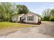 Single-story home featuring a driveway and lawn with mature trees and landscaping at 2005 Chalybeate Springs Rd, Fuquay Varina, NC 27526