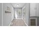 Bright hallway featuring a closet with lattice doors and hardwood flooring at 2005 Chalybeate Springs Rd, Fuquay Varina, NC 27526