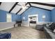 Spacious living room with grey sectional, vinyl floors, and seamless flow to the modern kitchen at 2005 Chalybeate Springs Rd, Fuquay Varina, NC 27526