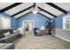 Bright living room with grey chair, couch, wood beams, vaulted ceilings and stylish decor at 2005 Chalybeate Springs Rd, Fuquay Varina, NC 27526