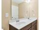 Bathroom features dual sinks, white countertop, and wooden cabinets at 225 Gulley Glen Dr, Garner, NC 27529