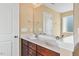 Dual sink bathroom features white sinks, brown cabinets, and framed mirror at 225 Gulley Glen Dr, Garner, NC 27529