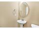 Neutral powder room features a pedestal sink, mirror, and toilet at 225 Gulley Glen Dr, Garner, NC 27529